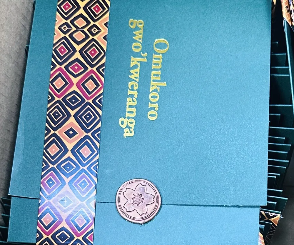 Teal invitation with African pattern detail